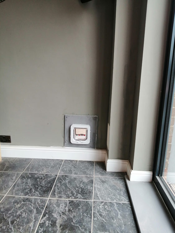 Cat flap tunnels fitted through the wall